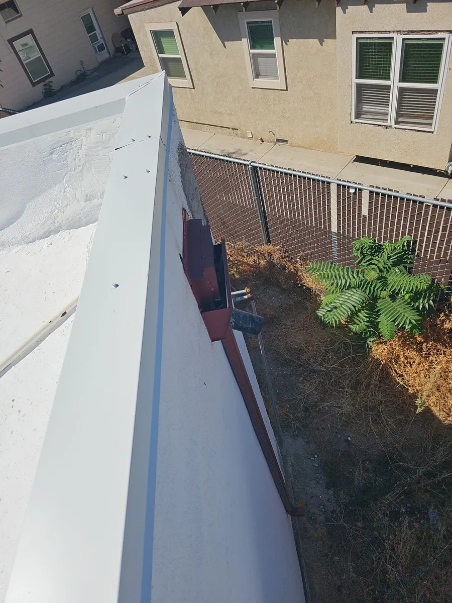 After: white elastomeric flat roof coating by Econo Roofing