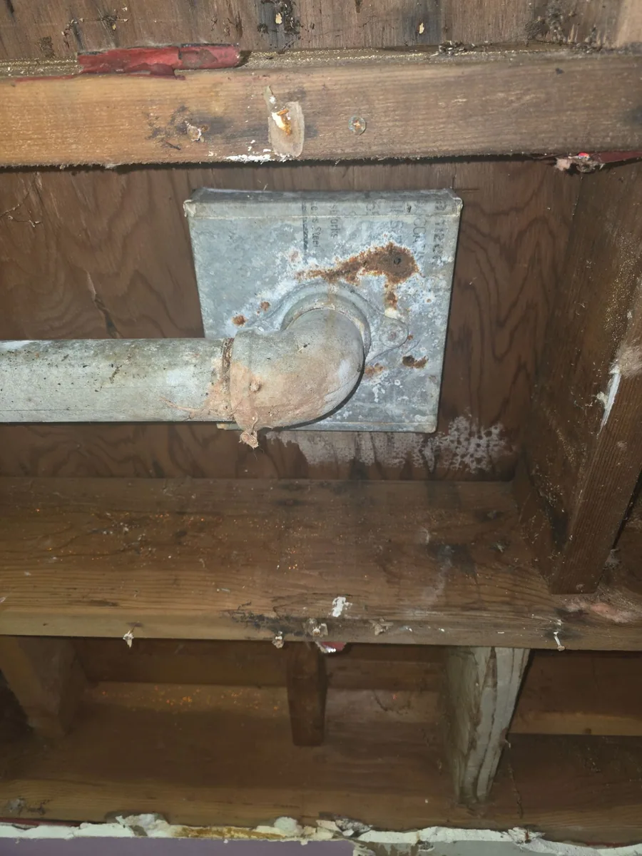 Before: rusted roof drain before repair