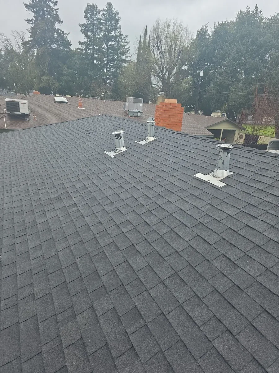 After: new charcoal asphalt shingle roof by Econo Roofing