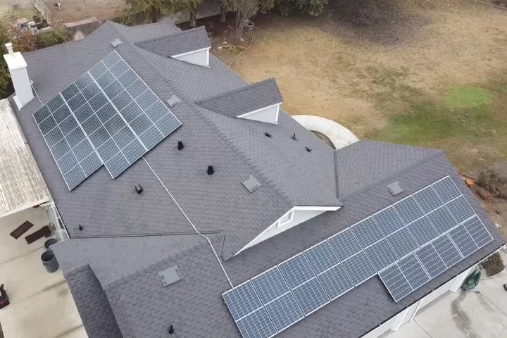After: aerial view of a new asphalt shingle roof with solar panels by Econo Roofing