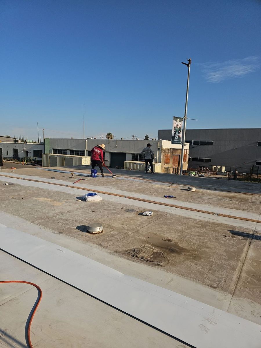 Econo Roofing crew at work on the Manteca High School roof during the TPO coating restoration