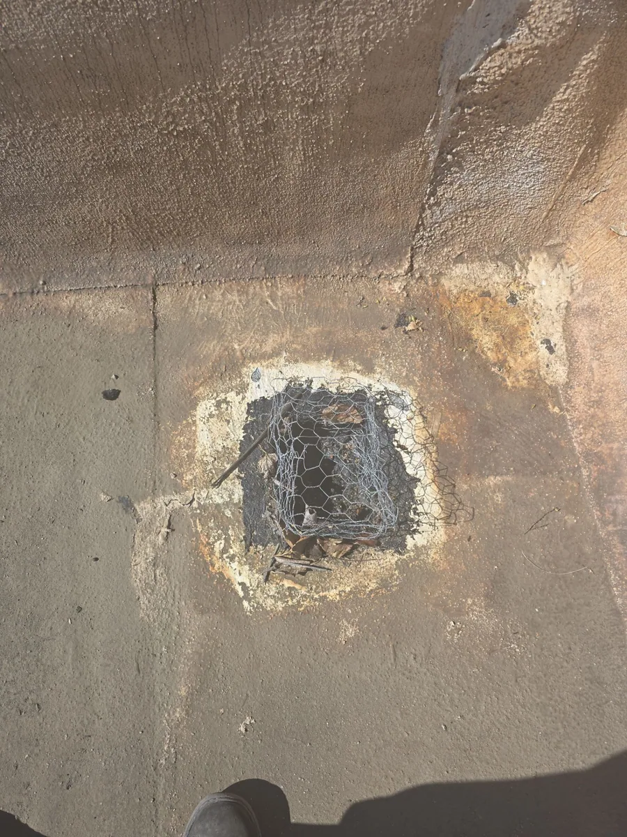 Broken roof drain on a Modesto flat roof, before repair