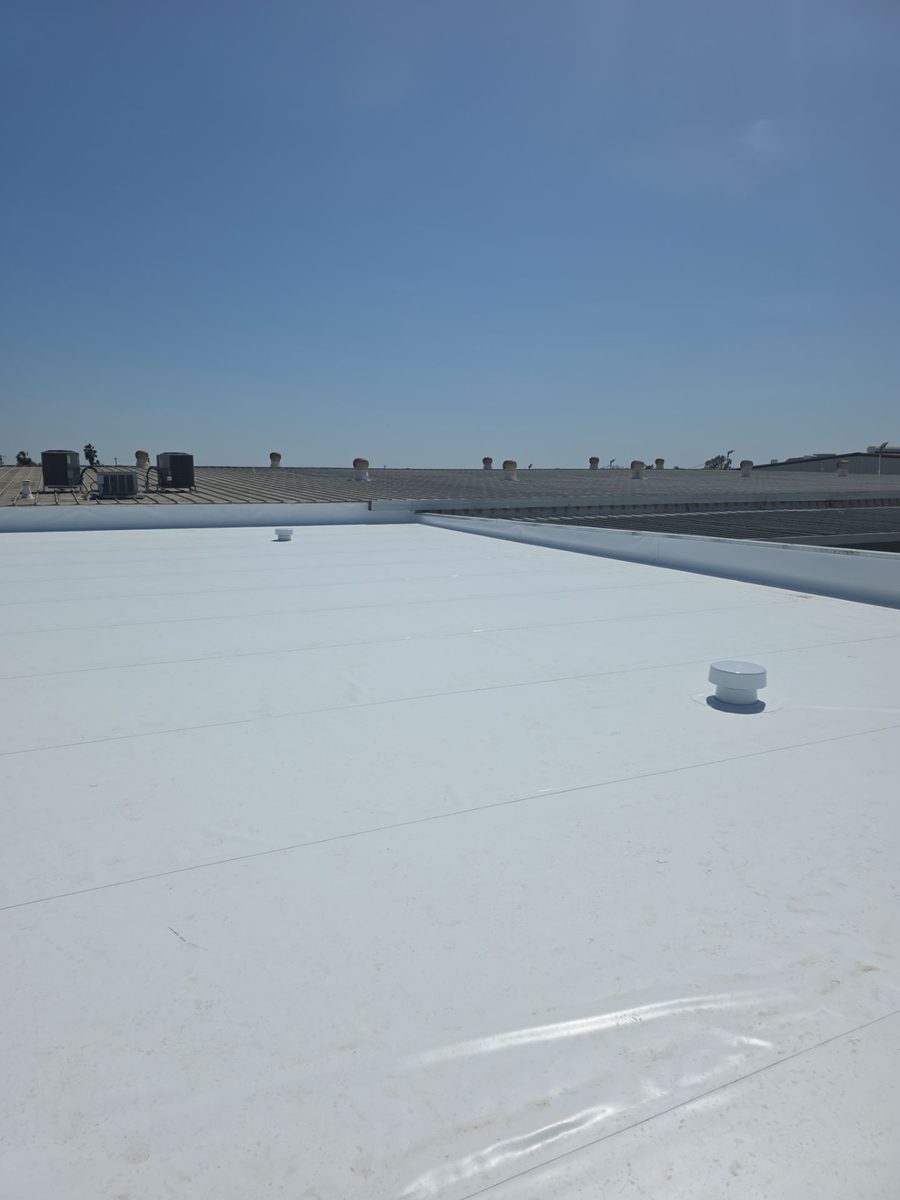 White coated commercial roof with new metal edge trim, downtown Modesto