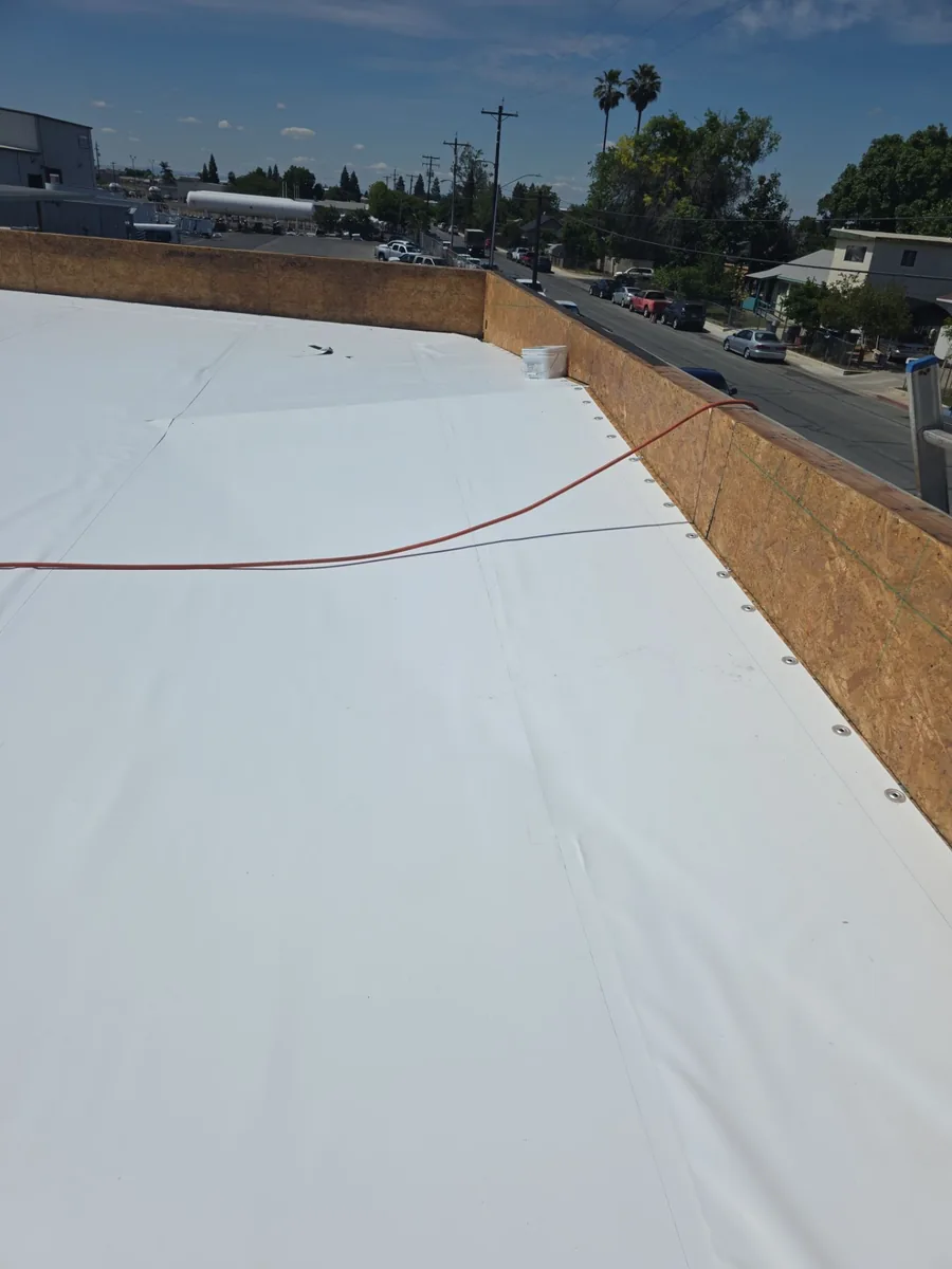 Merced commercial flat roof after coating — sealed, reflective white finish
