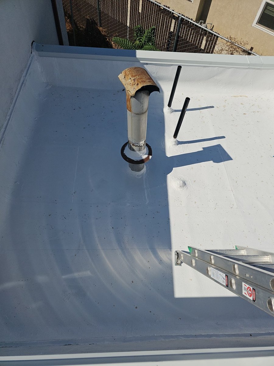 Freshly coated white silicone flat roof at Betos Bakery, Modesto